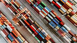Aerial view of shipping container port terminal. Colourful pattern of containers in harbor.