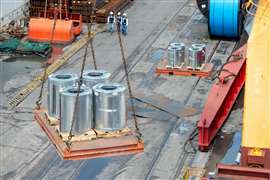 Galvanised steel coils moved at a shipping yard (Image: Adobe Stock)